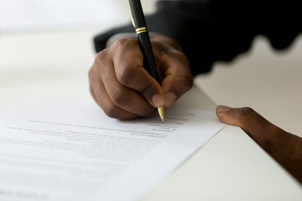 Close-up of a person writing a professional resume summary